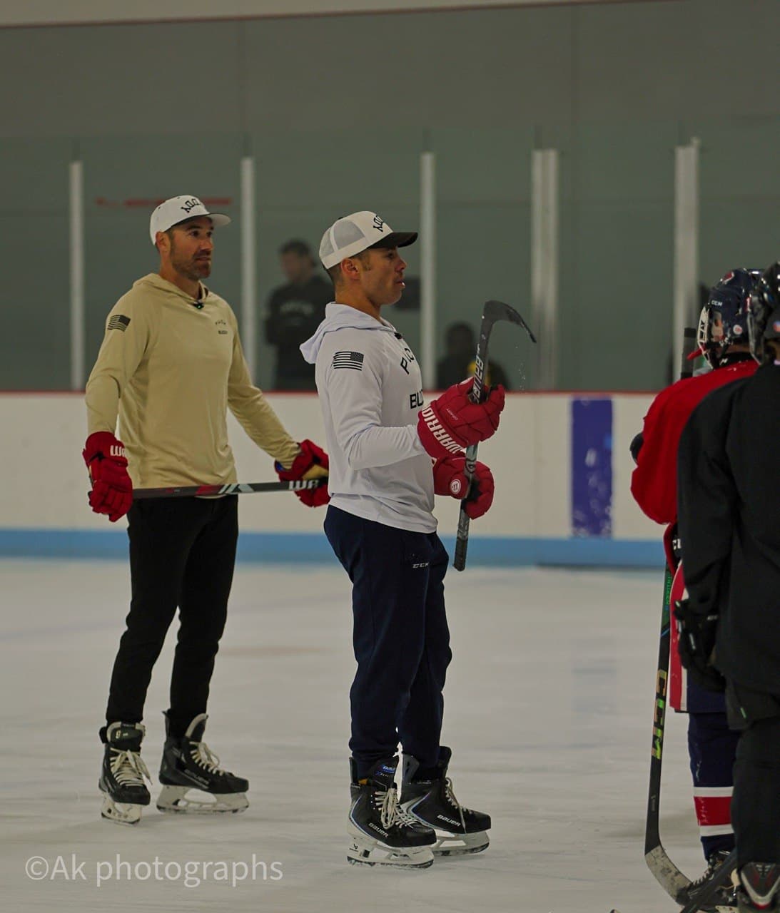 Puck Buddy coaches on the ice with players at a clinic.